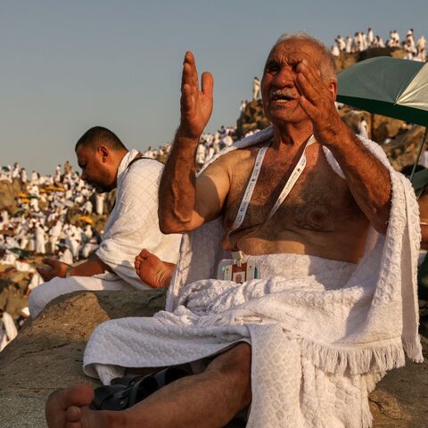 Muslim pilgrims pray at dawn on Saudi Arabia's Mount Arafat, also known as Jabal al-Rahma or Mount of Mercy, during the climax of the Hajj pilgrimage on June 15, 2024.