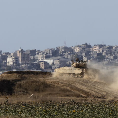 SOUTHERN ISRAEL, ISRAEL - JUNE 17: An Israeli tank moves along the border with the Gaza Strip as seen from a position on the Israeli side of the border on June 17, 2024 in Southern Israel, Israel. Israeli Army have agreed to a daily tactical pause in South Gaza to allow the passage of Humanitarian aid across the border. (Photo by Amir Levy/Getty Images)
