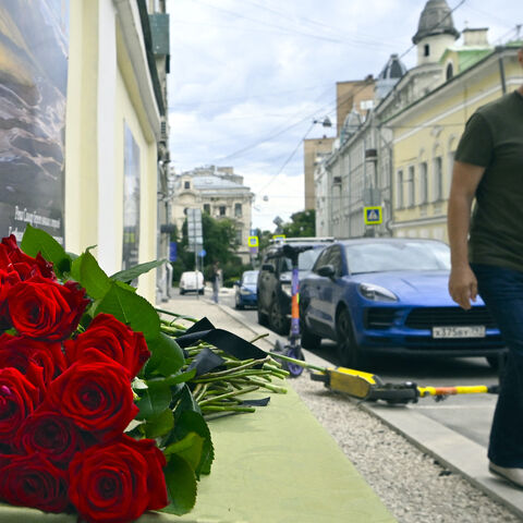 A man walks past the flowers laying in front of the representative office of Dagestan in Moscow on June 24, 2024, following terrorist attacks in Dagestan.  