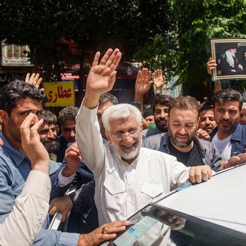 Saeed Jalili, ultraconservative former nuclear negotiator and Iran's presidential candidate, waves to the crowd after casting his vote at a polling station in Tehran during Iran's presidential election on June 28, 2024. 