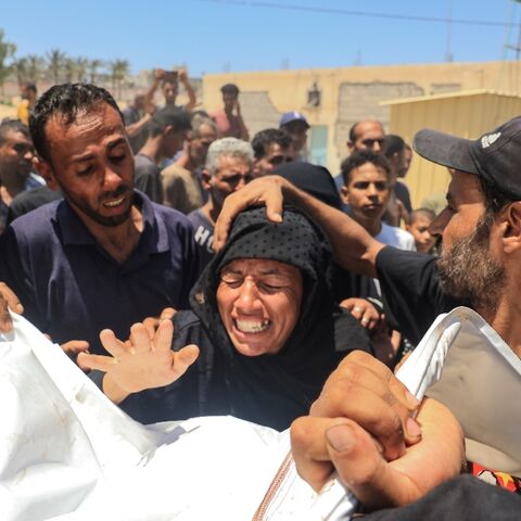 A woman reacts over the corpse of a family member after what the health ministry in Hamas-run Gaza called an Israeli strike on the Al-Mawasi area for displaced Palestinians