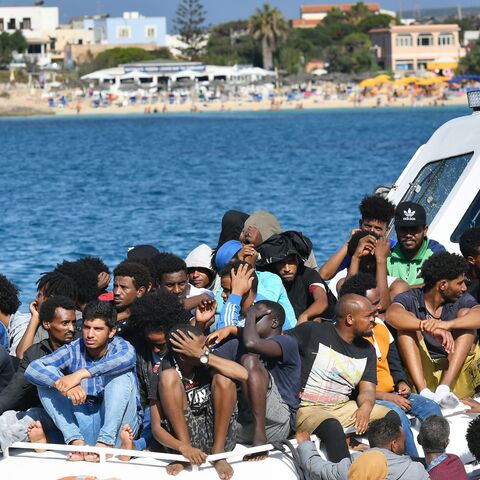Migrants from Tunisia and Lybia arrive onboard of an Italian Guardia Costiera (Coast Guard) boat in the Italian Pelagie Island of Lampedusa on Aug. 1, 2020.