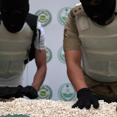 Officers of the Directorate of Narcotics Control of Saudi Arabia's Interior Ministry sort through tablets of Captagon.