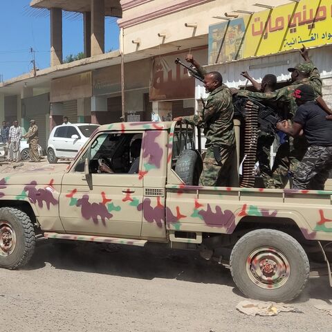 Sudanese soldiers and enrolled personnel drive a pickup truck mounted with a machine gun on a street in Gedaref city, Sudan, on Jan. 14, 2024.