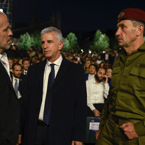 (L-R) Israel's domestic security agency 'Shin Bet' chief Ronen Bar, Mossad Director David Barnea, and army Chief of Staff Herzi Halevi talk as they arrive for a ceremony marking Holocaust Remembrance Day for the six million Jews killed during World War II, at the Yad Vashem Holocaust Memorial in Jerusalem on May 5, 2024. (Photo by Menahem Kahana / AFP) (Photo by MENAHEM KAHANA/AFP via Getty Images)