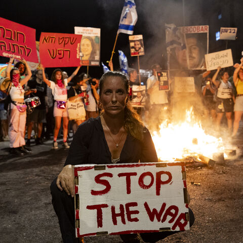 TEL AVIV, ISRAEL - JUNE 29: Families of hostages and supporters set a fire during a demonstration calling for an hostages deal and against the Israeli Prime Minister Benjamin Netanyahu on June 29, 2024 in Tel Aviv, Israel. Saturday night anti-government protest have occurred weekly for months, amid calls by many Israelis for Prime Minister Netanyahu to prioritize the return of hostages held in Gaza over the defeat of Hamas. Netanyahu has recently distanced himself further from a US-backed ceasefire proposal