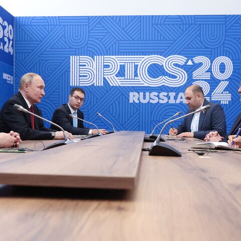 In this pool photograph distributed by the Russian state agency Sputnik, Russia's President Vladimir Putin (2L) meets with Iran's conservative Parliament Speaker Mohammad Bagher Ghalibaf (2R) on the sidelines of a BRICS (the bloc that includes Brazil, Russia, India, China and South Africa) parliamentary forum in Saint Petersburg on July 11, 2024. 