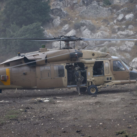 Israeli security forces leave in a helicopter near a site where a reported strike from Lebanon fell in Majdal Shams village in the Israeli-annexed Golan area on July 27, 2024. Israel's emergency medical service Magen David Adom said at least nine people were killed and 34 wounded including 17 in critical condition, after a rocket fired from Lebanon had hit the town of Majdal Shams in the Israeli-annexed Golan Heights. (Photo by Jalaa MAREY / AFP) (Photo by JALAA MAREY/AFP via Getty Images)