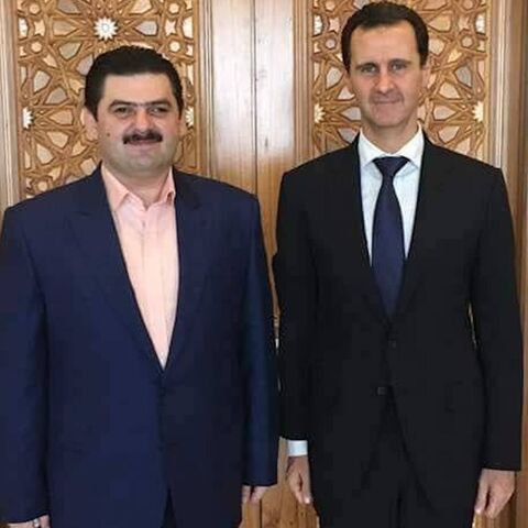 An undated image of Baraa al-Qaterji (L) with Syrian President Bashar al-Assad