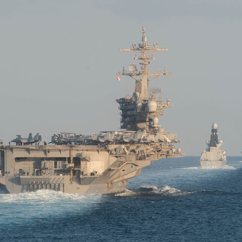 In this handout photo provided by the US Navy, the aircraft carrier USS Abraham Lincoln (L), the Royal Navy air defense destroyer HMS Defender and the guided-missile destroyer USS Farragut transit the Strait of Hormuz, Nov. 19, 2019.