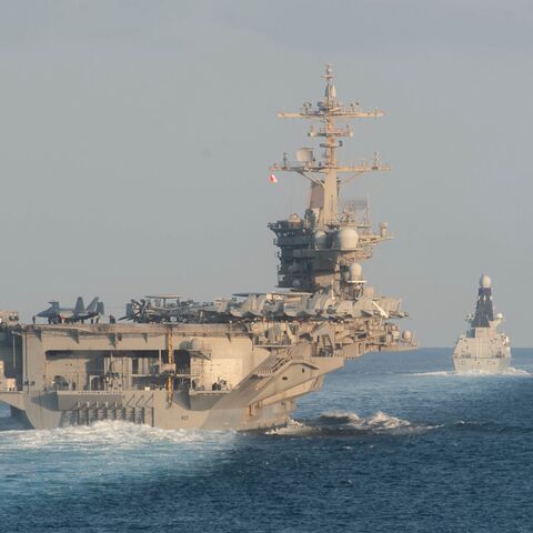 In this handout photo provided by the US Navy, the aircraft carrier USS Abraham Lincoln (CVN 72), left, the Royal Navy air defense destroyer HMS Defender (D 36) and the guided-missile destroyer USS Farragut (DDG 99)