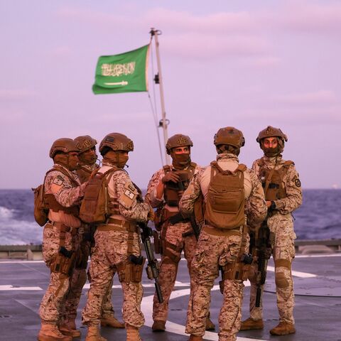 Saudi security officers stand guard onboard a Saudi vessel docked off the seaport of Port Sudan on April 30, 2023, during evacuations efforts from Sudan. - Heavy fighting again rocked Sudan's capital as tens of thousands have fled the bloody turmoil and a former prime minister warned of the "nightmare" risk of a descent into full-scale civil war. Foreign nations have scrambled to evacuate thousands of their citizens by air, road and sea since the fighting plunged the poverty-stricken country into deadly tur