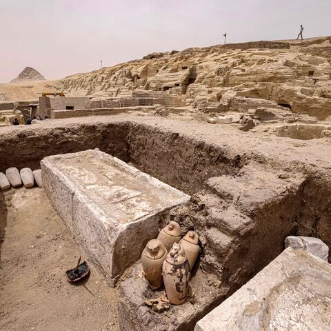 Visitors tour the site in the Saqqara necropolis south of Cairo, where archaeologists unearthed two human and animal embalming workshops, as well as two tombs, on May 27, 2023. The head of Egypt's Supreme Council of Antiquities, told reporters the embalming workshops, where humans and animals were mummified, "date back to the 30th dynasty" which reigned around 2,400 years ago. (Photo by Khaled DESOUKI / AFP) (Photo by KHALED DESOUKI/AFP via Getty Images)