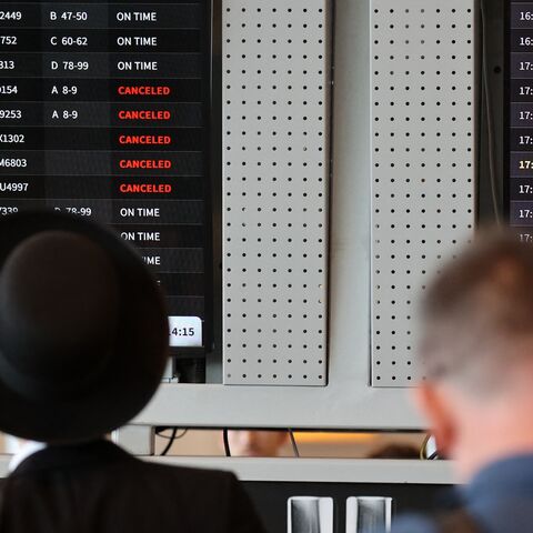 Passengers look at the flight board at Ben Gurion Airport near Tel Aviv on Aug. 6, 2024.