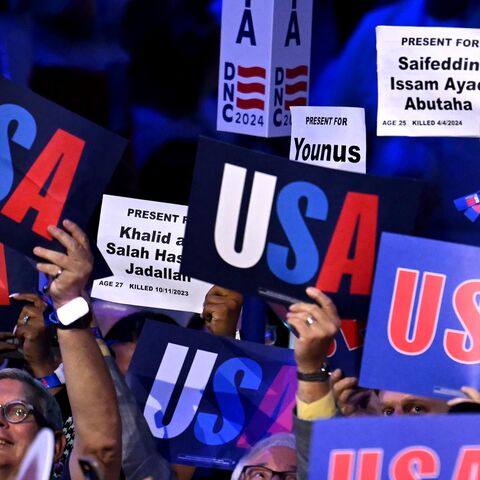 Attendees hold up signs with the names of people who died in the Gaza war on the second day of the Democratic National Convention (DNC) at the United Center in Chicago, Illinois, on August 20, 2024.