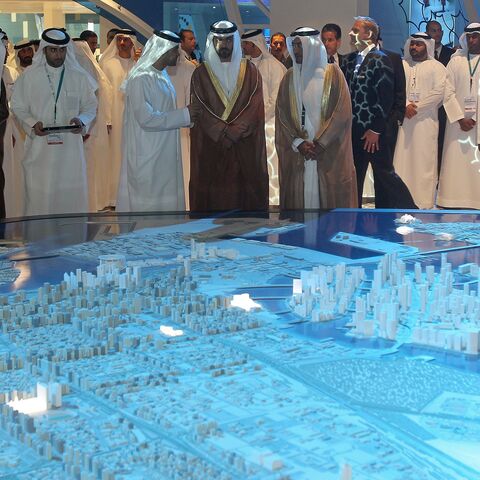 Sheikh Hamed bin Zayed Al Nahyan (C), who was recently named to head the Abu Dhabi Investment Authority, looks at a model of the Capital City District project.