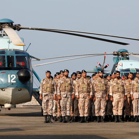 This handout picture provided by the Iranian Army office on Dec. 24, 2023, shows soldiers attending the unveiling ceremony of a new missile system.