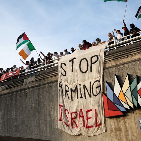 Protesters wave Palestinian flags.