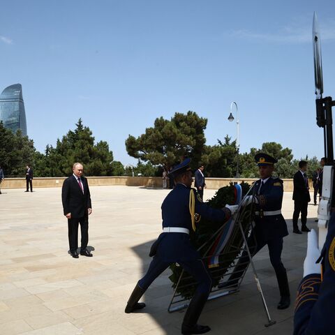 In this pool photograph distributed by Russian state agency Sputnik, Russia's President Vladimir Putin attends a wreath-laying ceremony at the Eternal Flame Memorial in Baku on August 19, 2024. (Photo by Mikhail TERESHCHENKO / POOL / AFP) (Photo by MIKHAIL TERESHCHENKO/POOL/AFP via Getty Images)