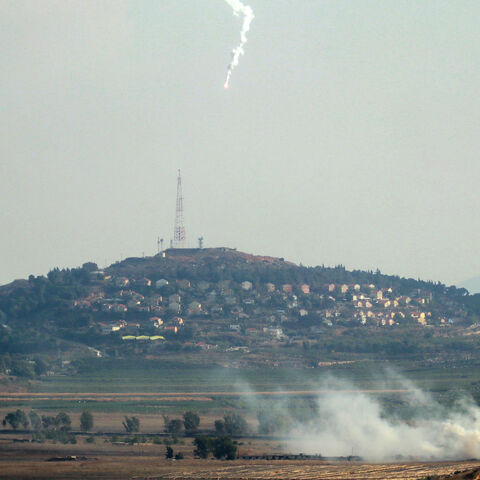 Smoke rises and a flare is deployed in the southern Lebanese Marjayoun plain after being hit by Israeli shelling on Sept. 7, 2024, amid the ongoing cross-border clashes between Israeli troops and Hezbollah fighters. 