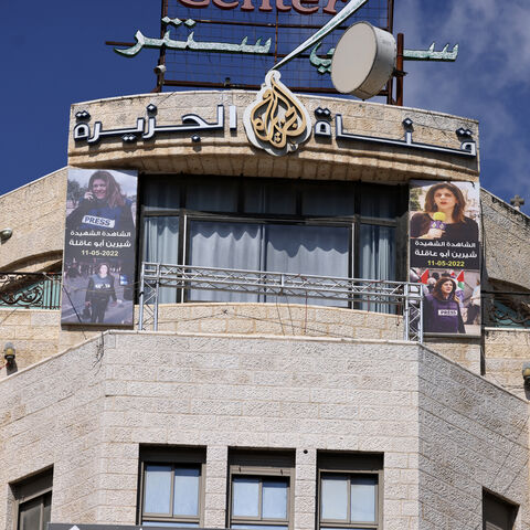 Pictures of slain al-Jazeera journalist Shireen Abu Akleh hang on the facade of the building housing the television station's office in Ramallah in the occupied West Bank, after Israel issued a 45-day closure order on September 22, 2024. Al Jazeera reported on September 22 that Israeli troops had raided its Ramallah bureau and informed journalists for the Doha-based network in the occupied West Bank to shutter operations. (Photo by JAAFAR ASHTIYEH / AFP) (Photo by JAAFAR ASHTIYEH/AFP via Getty Images)