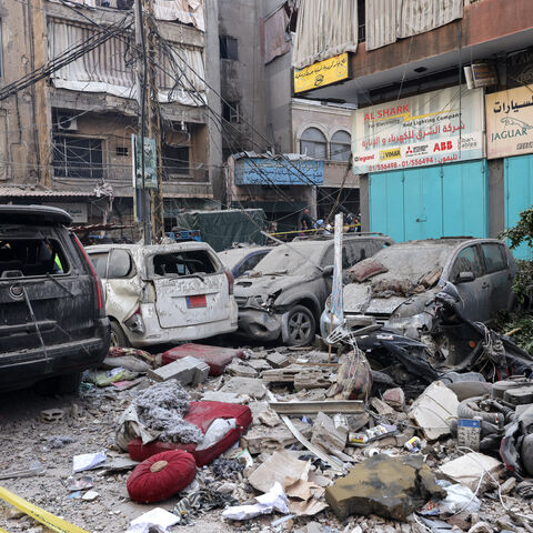 Debris lie around destroyed vehicles in a street under a residential building whose top two floors were hit by an Israeli strike in the Ghobeiri area of Beirut's southern suburbs on September 24, 2024. A Lebanese security source said on September 24 that an Israeli strike hit Hezbollah's south Beirut stronghold, as the Israel army confirmed it carried out the strike in the Lebanese capital without giving further details. (Photo by ANWAR AMRO / AFP) (Photo by ANWAR AMRO/AFP via Getty Images)