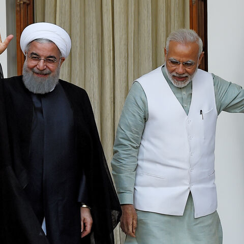 Iran's former President Hassan Rouhani (L) waves to the media as India's Prime Minister Narendra Modi looks on before a meeting at Hyderabad house, New Delhi, India, Feb. 17, 2018.