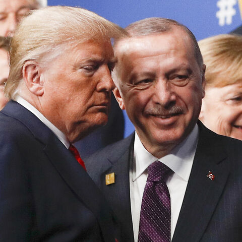 TOPSHOT - US President Donald Trump (L) and Turkey's President Recep Tayyip Erdogan (R) leave the stage after the family photo to head to the plenary session at the NATO summit at the Grove hotel in Watford, northeast of London on December 4, 2019. (Photo by PETER NICHOLLS / POOL / AFP) (Photo by PETER NICHOLLS/POOL/AFP via Getty Images)