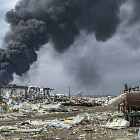 Thick smoke billows from a raging fire at a storage tank of the al-Awda oil field facility near al-Qahtaniyah in northeastern Syria close to the Turkish border on Dec. 24, 2023, a day after a reported Turkish strike. 