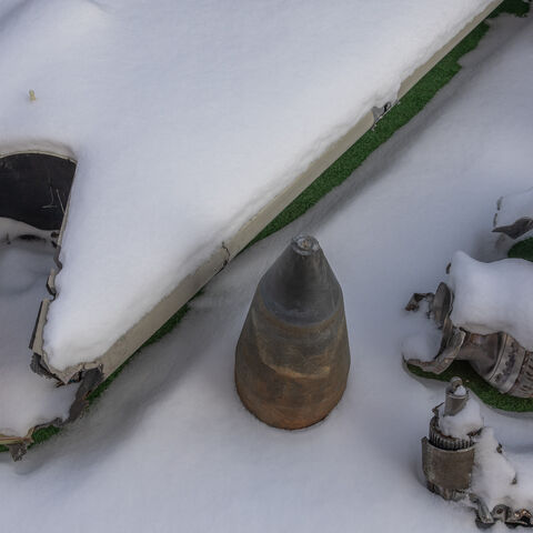 This photograph taken on January 16, 2024, shows partly covered in snow the wreckage of Iranian made Shahed drone launched at Ukraine, at Kyiv Scientific Research Institute of Forensic Expertise, in Kyiv, amid the Russian invasion of Ukraine. At a research facility in Kyiv, forensic experts pour over the wreckage of missiles, working to confirm that despite unprecedented sanctions, Russia is still using imported components to attack Ukraine. The courtyard of the Kyiv Scientific Research Institute of Forensi