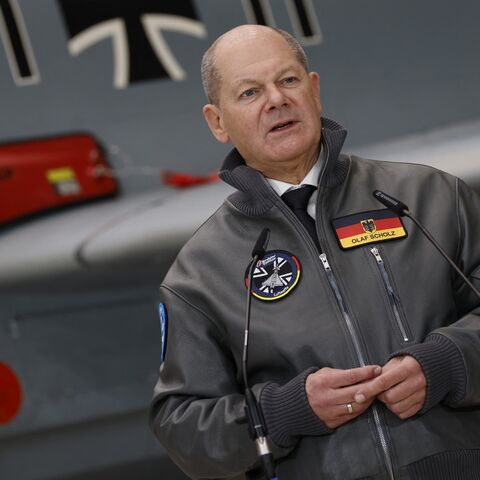 German Chancellor Olaf Scholz stands in front of a Eurofighter Tycoon combat aircraft as he speaks during a visit to the Bavarian plant of European aircraft maker Airbus in Manching, southern Germany, January 19, 2024.