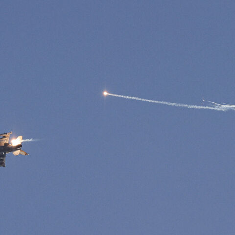 This picture taken from a position in northern Israel shows an Israeli Air Force fighter jet firing flares as it flies to intercept a hostile craft that launched from Lebanon over the border area with south Lebanon on July 7, 2024, amid ongoing cross-border clashes between Israeli troops and Hezbollah fighters. (Photo by Jalaa MAREY / AFP) (Photo by JALAA MAREY/AFP via Getty Images)