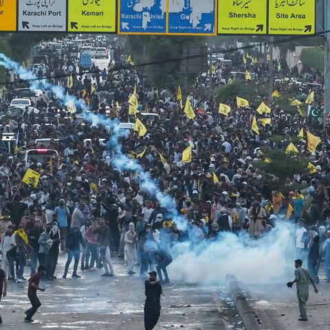 Members of Imamia Students Organization, a Shiite Muslim student wing, take part in a protest to condemn the killing of Hassan Nasrallah, as policemen fire tear gas shells to disperse them in Karachi on Sept. 29, 2024. 