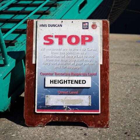 A sign about the heightened level of the counterterrorism response is seen outside HMS Duncan while docked at the Port of Limassol on the Mediterranean island of Cyprus, on Oct. 2, 2024. 