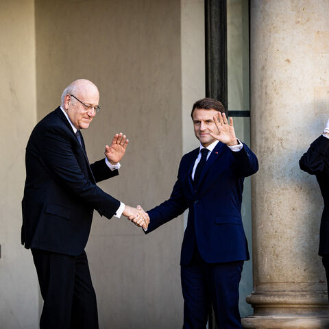 France s President Emmanuel Macron receives Lebanon s Prime Minister Najib MIKATI before their bilateral meeting at the Elysee Palace in Paris, France on October 23, 2024. Context of war between Lebanon and Israel, extension of the Israeli-Palestinian conflict, solidarity with lebanese people, the two men shake hands on the stoop at the top of the steps and look towards the photographers. (Photo by Amaury Cornu / Hans Lucas / Hans Lucas via AFP) (Photo by AMAURY CORNU/Hans Lucas/AFP via Getty Images)