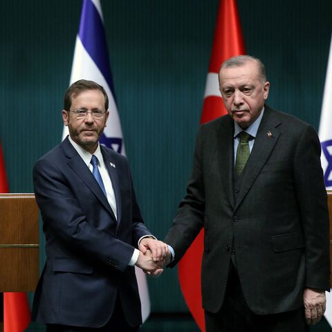 Israeli President Isaac Herzog (L) and his Turkish counterpart Tayyip Erdogan shake hands during a press conference in Ankara, on March 9, 2022. (Photo by AFP) (Photo by STR/AFP via Getty Images)