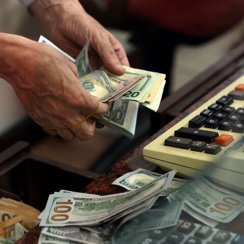 A teller counts US dollar bills at an exchange office, Ankara, Turkey, July 20, 2023.