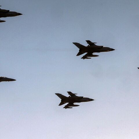 Royal Saudi Air Force Panavia Tornado and F-15 Eagle fighter aircraft fly over during an airshow.