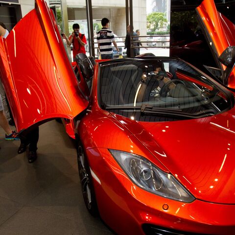 A group of people are seen visiting the first Chinese dealership unveiled by British supercar maker Mclaren Automotive on Sept. 12, 2013 in Shanghai.