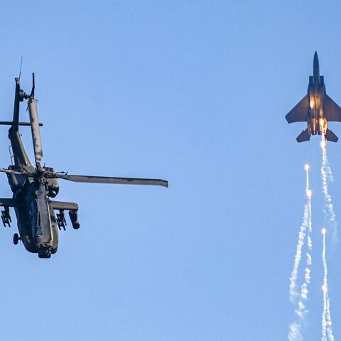 Singaporean Air Force's F-15SG fighter jet and Apache helicopter perform during a preview of the Singapore Airshow in Singapore on Feb. 18, 2024. 