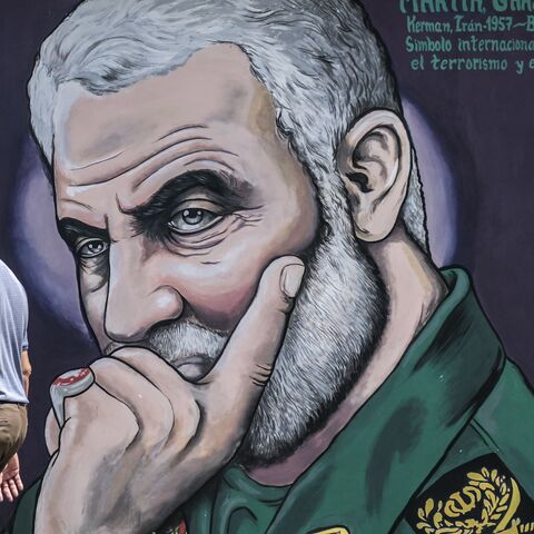 A man walks past a mural depicting slain commander of the IRGC's Quds Force Qasem Soleimani in Caracas, Venezuela, on April 26, 2024.