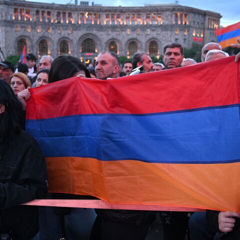 Armenian protesters hold a flag of Armenia as they gather to rally against land transfer to Azerbaijan, on Yerevan's Republic Square on May 10, 2024. Armenia has agreed to hand over territory it has controlled since the 1990s and started border delimitation efforts in a bid to secure an elusive peace deal with Baku and avoid another bloody conflict. (Photo by KAREN MINASYAN / AFP) (Photo by KAREN MINASYAN/AFP via Getty Images)