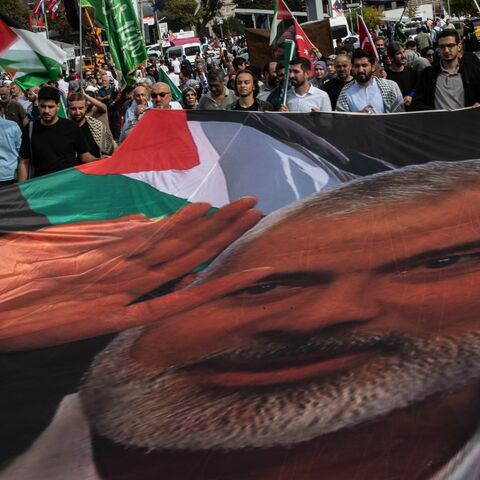 People carry the picture of late Hamas leader Ismail Haniyeh as they march during a protest to express support for Palestinians in Gaza on the eve of the first anniversary of the Oct. 7 attacks, on Oct. 06, 2024, in Istanbul, Turkey. 