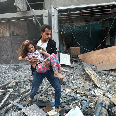 A Palestinian man carries away an injured child from a home that was hit in an Israeli strike on the Jabalia refugee camp in the northern Gaza Strip, on November 7, 2024. Israel's military has been conducting a sweeping air and ground assault in northern Gaza since October 6, 2024, particularly around Jabalia, Beit Lahia and Beit Hanoun, saying it aims to prevent Hamas regrouping. (Photo by AFP) (Photo by -/AFP via Getty Images)