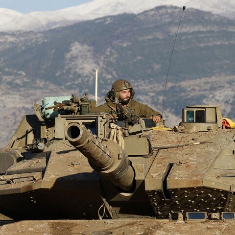 An Israeli soldier sits in a tank stationed near the border with Lebanon in the Upper Galilee area in northern Israel, on Nov. 26, 2024.