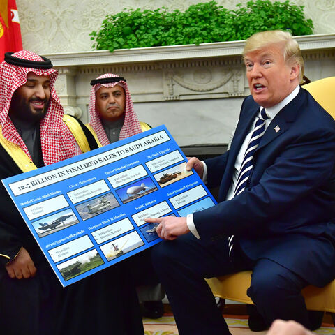 WASHINGTON, DC - MARCH 20: President Donald Trump (R) holds up a chart of military hardware sales as he meets with Crown Prince Mohammed bin Salman of the Kingdom of Saudi Arabia in the Oval Office at the White House on March 20, 2018 in Washington, D.C. (Photo by Kevin Dietsch-Pool/Getty Images)