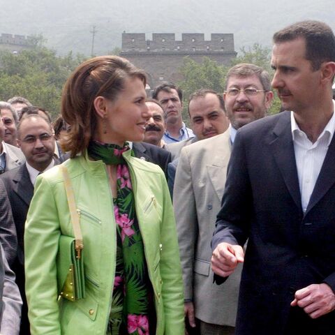  Visiting Syrian President Bashar al-Assad (R) and his wife, Asma, (C) visit the Great Wall near Beijing, on June 22, 2004, during the Middle East leader's first full day in the Chinese capital.