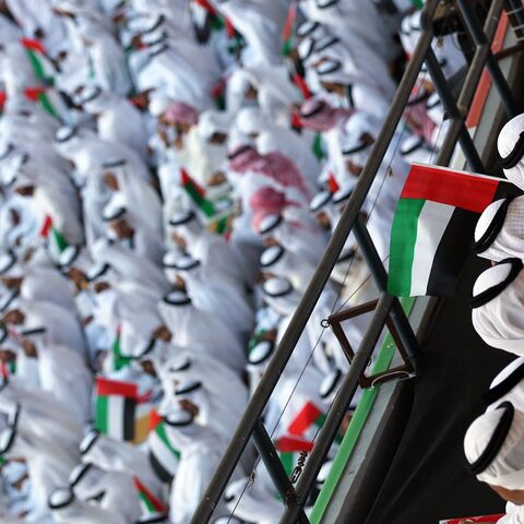 Emiratis wave national flags as citizens celebrate their country's 40 years of independence on National Day, in Abu Dhabi, on Dec. 2, 2011.