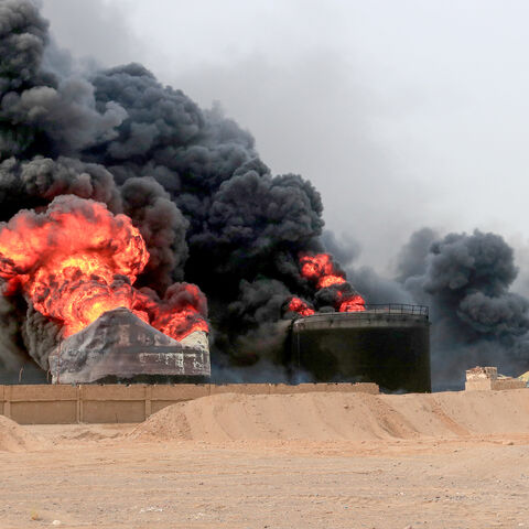 Thick smoke billows from a raging fire at oil storage tanks a day after Israeli strikes on the port of Yemen's Huthi-held city of Hodeida on July 21, 2024. Yemen's Huthi rebels on July 21 promised a "huge" retaliation against Israel following a deadly strike on the port of Hodeida, as regional fallout widens from months of war in Gaza. (Photo by AFP) (Photo by -/AFP via Getty Images)