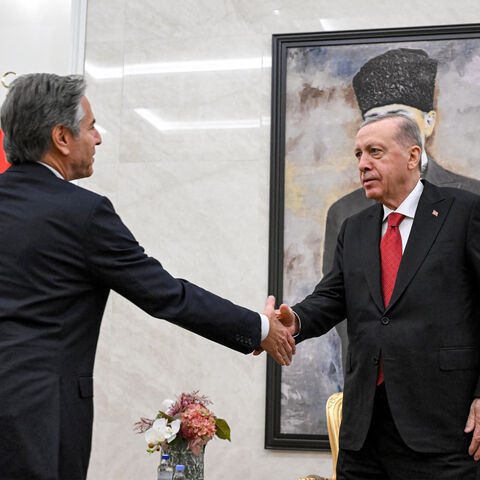 US Secretary of State Antony Blinken (L) shakes hands with Turkey's President Recep Tayyip Erdogan (R) before a picture of the founder and first president of the Turkish Republic Mustafa Kemal Ataturk, during their meeting at Ankara Esenboga Airport on December 12, 2024. (Photo by ANDREW CABALLERO-REYNOLDS / POOL / AFP) (Photo by ANDREW CABALLERO-REYNOLDS/POOL/AFP via Getty Images)